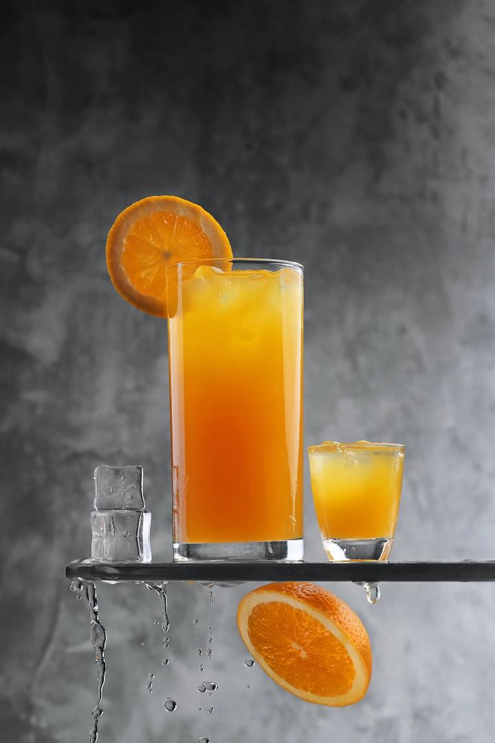 clear drinking glass with orange juice
