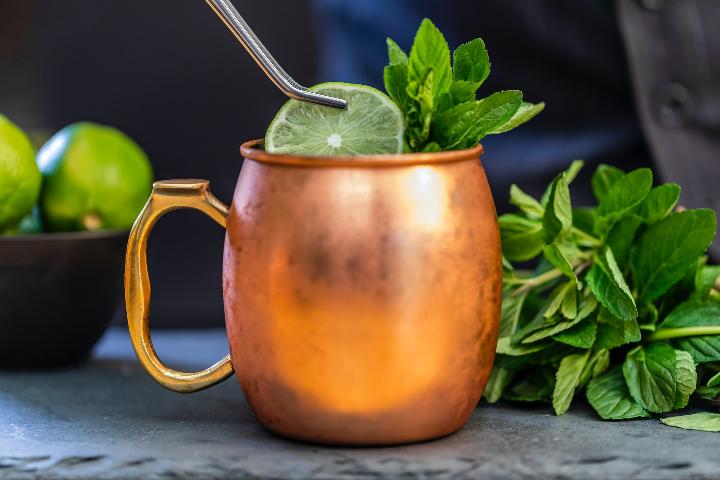 brass-colored mug with sliced lime